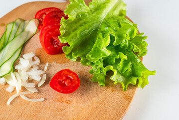 Fresh salad ingredients on a cutting board. Perfect for food blogs, recipes, and healthy eating content.