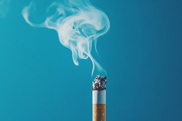 Close-up of a lit cigarette with smoke swirling against a blue background
