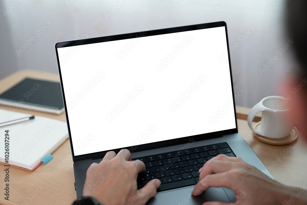 Poster close-up image of a man working on laptop computer at a table, typing on the laptop keyboard. the la