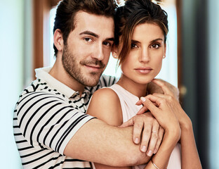 Fototapeta premium Loyalty, portrait and couple hug in home with trust and love for care, romance and bonding. Support, commitment and people embrace in marriage relationship together to relax in apartment in Italy