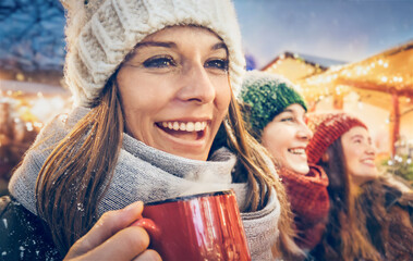 Three girls having fun at a Christmas market