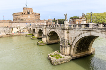 Obraz premium Rome, Italy - April 09, 2024: Castel Santo Angelo in Rome with tourists crowding its surroundings in Rome, Italy