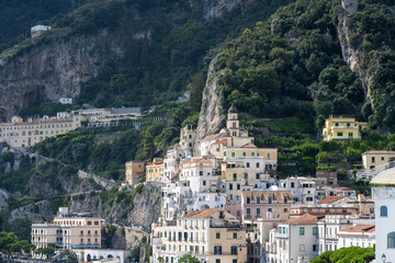 Obraz premium Amalfi town located at the foot of steep cliffs on the southwest coast of Italy