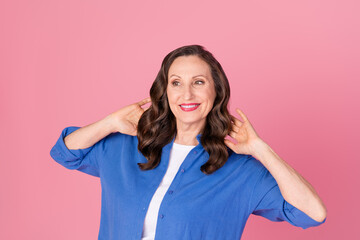 Photo portrait of nice pensioner female look empty space hold hair wear trendy blue outfit isolated on pink color background