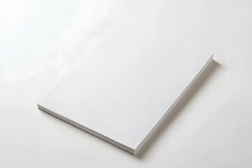 A simple, blank sheet of paper lies on a plain surface, showcasing its smooth texture and crisp edges.