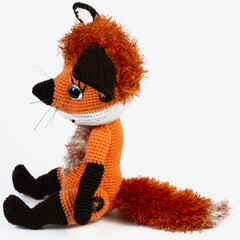Amigurumi doll fox red background white isolated