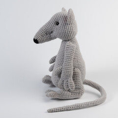dolls migurumi gray rat with a long tail sits background white isolated