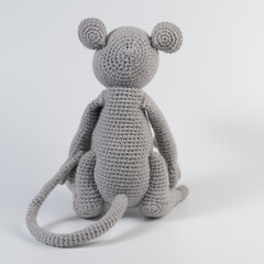 dolls migurumi gray rat with a long tail sits background white isolated
