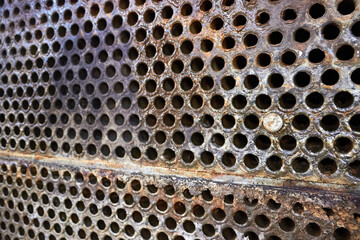 Tube sheet or place of heat exchanger boiler closeup selective focus background. Disconnected muted...
