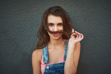 Woman, portrait and hair mustache with playful, fun and kissing face on gray background wall. Girl, silly smile and relaxing pout with care, happiness and comic joke for funky urban gen z fashion