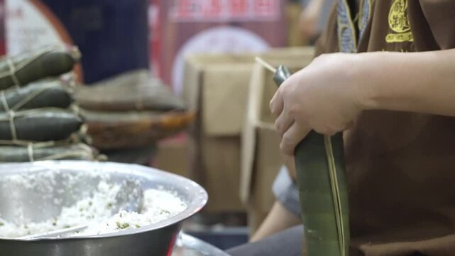 making zong zi in kitchen