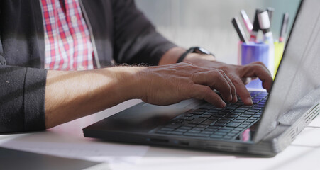 close up of elder older angry man hand do job work from home typing email online chat use laptop...