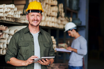 Happy, plumbing and portrait of man with tablet in workshop, factory and production for...