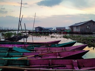 Traditional fishing boats are parked on the shore of the lake