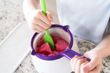 Crafting Sweet Treats: Young Chef Prepares Chocolate-Dipped Pretzels