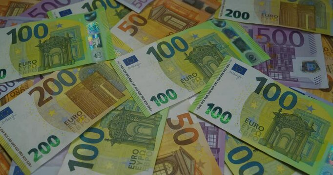 Rotating Euro banknotes of various denominations. Banknotes 500, 200, 100 and 50 Euro. Real euro money of various colors and nominals. Cinema 4K 60fps video with darkening