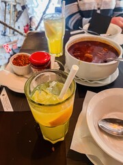 Traditional Hungarian hot goulash soup in a deep bowl with a ladle served on the table