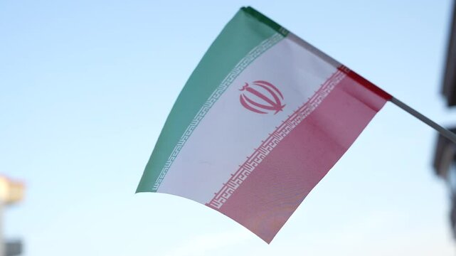 Iran flag with clear sky in the background. The conflict between Israel and Iran.