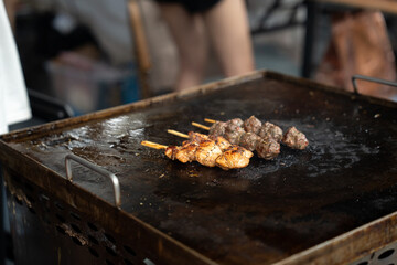 Grilled meat skewers in a herb marinade on a grill pan, top view, Fresh turkey meat skewers, Kabab, beef, street food