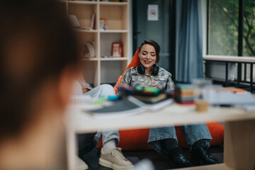 Two students studying together in a modern library. One student is smiling while using a laptop, creating a collaborative and relaxed learning environment.