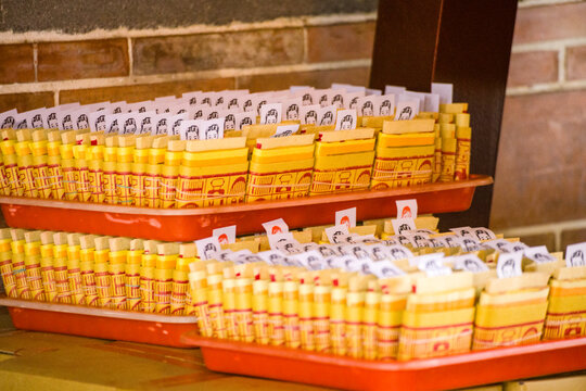  stacks of golden Joss papers arranged neatly on a table for religious ceremonies and offerings