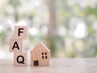 Miniature house, Wooden block with word the FAQ. The concept of question or answer about Property,...