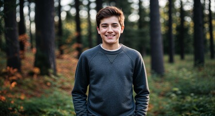 Teen Canadian guy in a casual sweater smiling portrait photo forest background