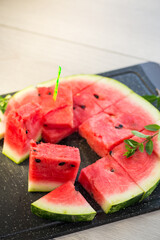 pieces of ripe red watermelon, close-up, on a board