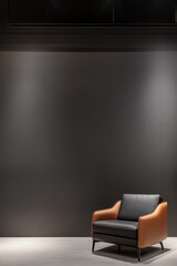 Modern leather armchair in minimalist room with dark wall and soft lighting
