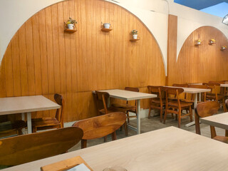 The interior design of a cafe that looks elegant and is dominated by wood materials.