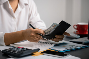 Person manage finances wisely, saving cash from their salary to ensure stable income for future...