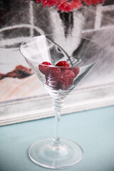 Fresh raspberries in a transparent glass
