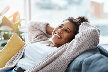 Woman, stretching and happy on sofa for relax, comfort and positivity in home living room. Girl, student and smile on couch for study break, stress free and optimistic on weekend in Brazil apartment