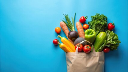 Colorful grocery bag spilling fresh produce on blue background