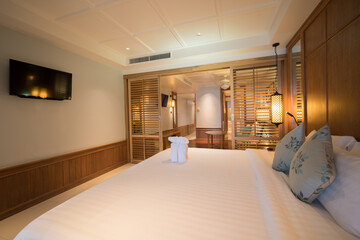 Interior of modern bedroom at hotel with white bed and pillow.