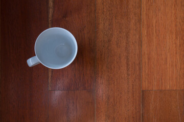 A cups of coffee on orange color wooden table background