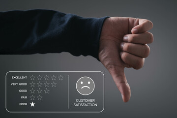 Hand giving a thumbs down next to a poor customer satisfaction rating, highlighting negative feedback.