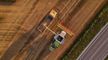 Aerial view of a combine harvester working in a field.