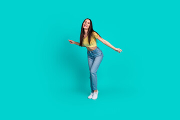 Full body portrait of nice young woman dancing wear top isolated on turquoise color background