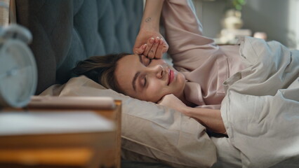 Smiling girl waking up in morning sunlight closeup. Happy woman checking phone