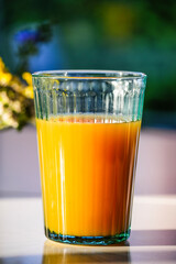 Fruit juice on the breakfast table in the morning sunlight