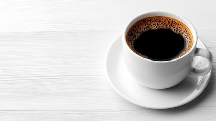 Obraz premium A white coffee cup with a black liquid in it sits on a wooden table