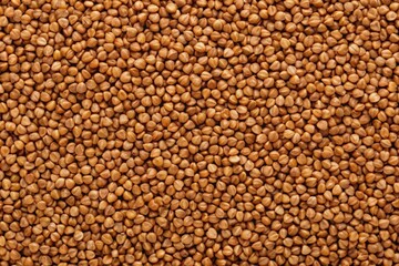 Uncooked brown buckwheat grains background