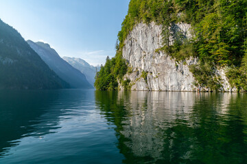 Mountain reflecting in lake in sun