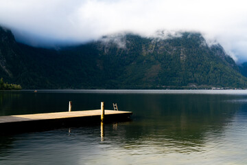 lake with dock and mountains in Overtraun, Austria