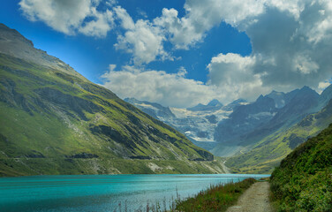 Magnificent views of a mountain in Switzerland next to a lake and with a glacier in the background
