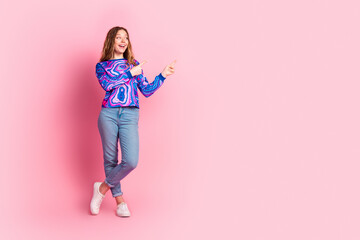 Full size photo of pretty young woman direct fingers empty space ad wear pullover isolated on pink color background