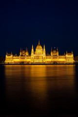 Beautiful Parliament in the city of Budapest with everything illuminated at night, Hungary