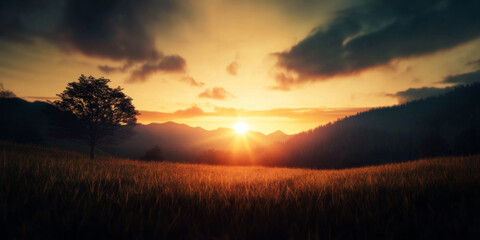Obraz premium Stunning sunset over a mountain landscape with a solitary tree in a grassy field