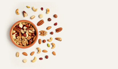 Walnut, macadamia nut, cashew nut, pecan on the plate and isolated on light background. Pile of mixed nuts on the light background.